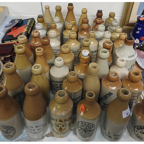 42 - Collection of named salt glazed stoneware ginger beer and water bottles from various areas of the co... 