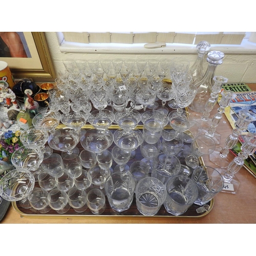 45 - Mixed glassware including two decanters with incorrect stoppers, four candlesticks, whiskey tumblers... 