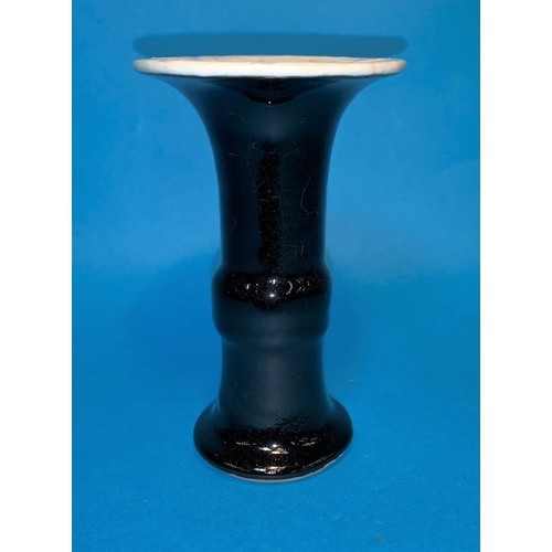 256 - A Chinese black and white glazed Gu vase with blue concentric circles to base height 5