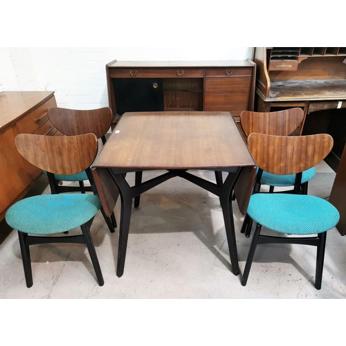636 - A 1950's G-Plan walnut dining suite with ebonised legs and panels, comprising drop leaf table, m4 ch... 