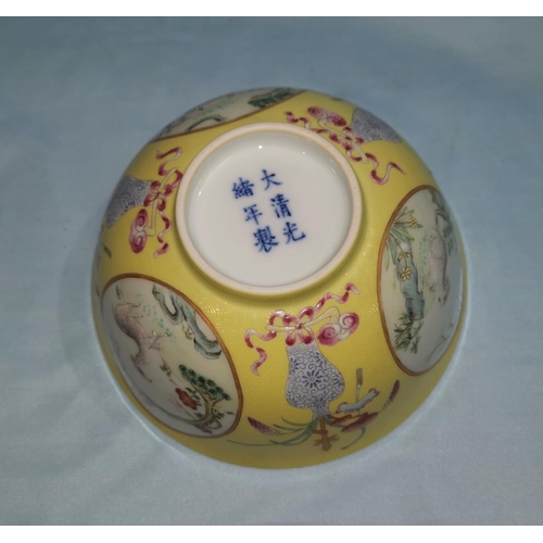 260 - A Chinese porcelain bowl decorated  with 3 urns alternating with circular panels on yellow textured ... 