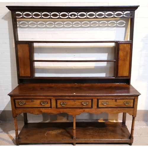 593 - A George III period golden oak Welsh dresser with crossbanded decoration, the delft rack top with mo... 