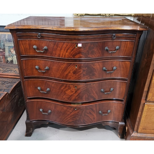 599A - A Georgian style mahogany bachelors chest with serpentine front, 4 long graduating drawers and brush... 