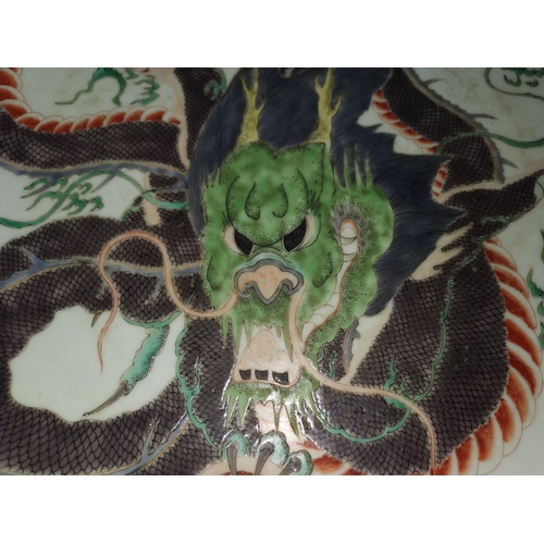 123 - A famille verte charger in the style of the Chinese Kang Shi period, decorated with large dragon to ... 