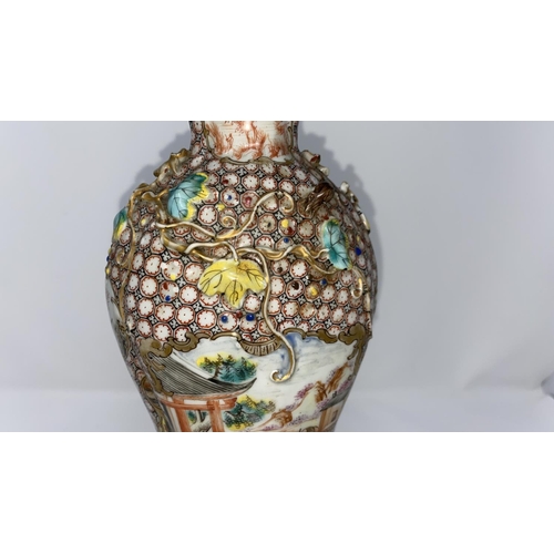 314a - A Chinese porcelain vase with enamel decoration of traditional scenes, relief of leaves and vines to... 