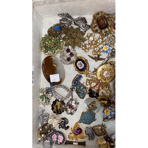 378 - A large selection of costume jewellery brooches