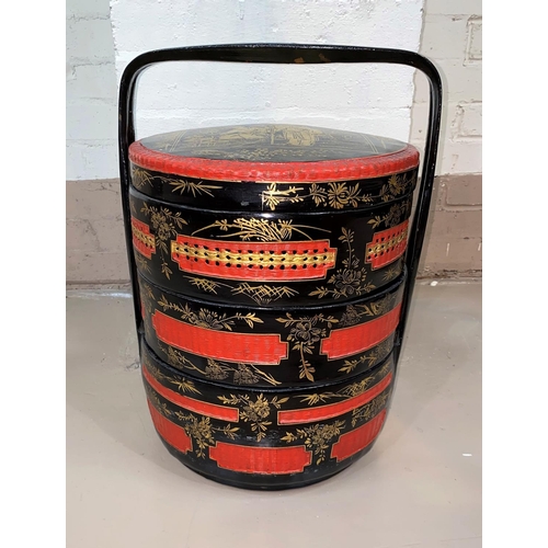 377 - A 20th century Chinese picnic set, 3 height and circular in black and red lacquer