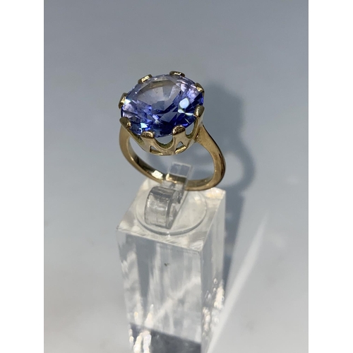 365 - A lady's yellow metal dress ring set with a large circular Tanzanite, unmarked but tests as 9ct, siz... 
