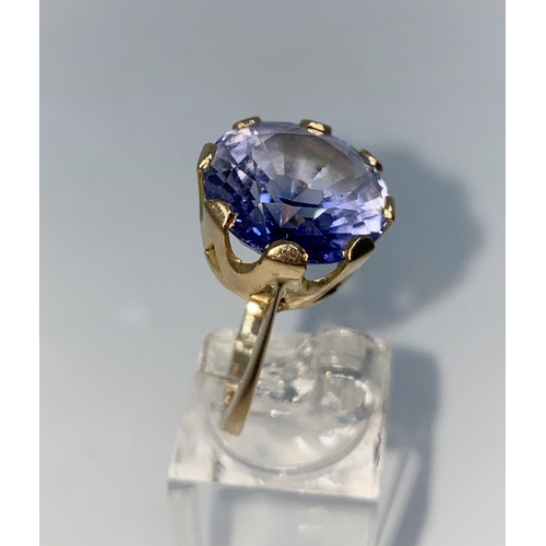365 - A lady's yellow metal dress ring set with a large circular Tanzanite, unmarked but tests as 9ct, siz... 