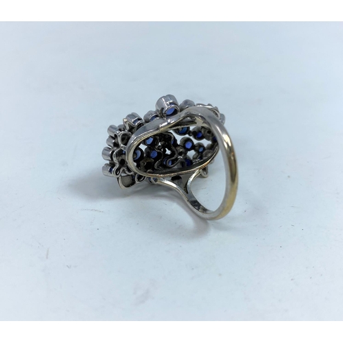 366 - A 1970's lady's modernist multi stone diamond and sapphire ring on white metal shank stamped 18ct an... 