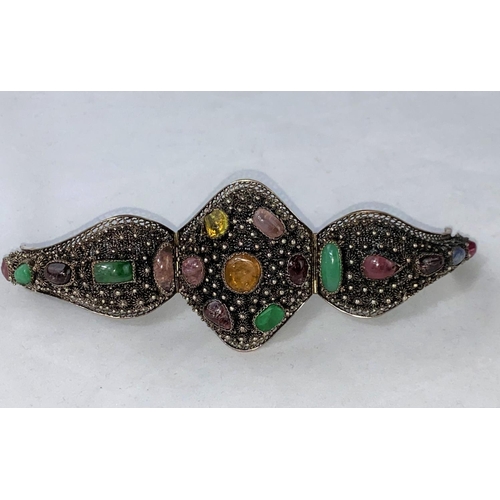 300A - An ornate Eastern silver bracelet set with multi coloured stones with matching earrings, ring and br... 