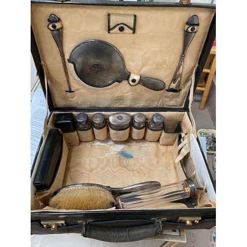 553 - A gent's part  fitted travelling vanity case by Finnigans, London & Manchester, silver top storage j... 