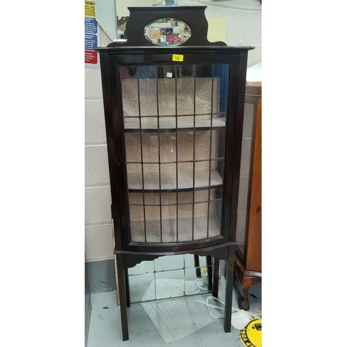 755 - A late 19th/early 20th century ebonised display cabinet with leaded glass door, small oval mirror ba... 
