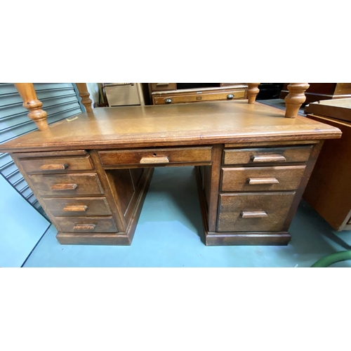 744 - A 1930's oak desk with central frieze drawer, 4 drawers and slide to each pedestal, with similar arm... 