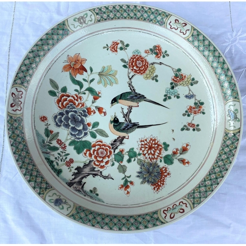 346A - A large Chinese famille verte charger decoarted with flowers and birds on a branch, diameter 43cm