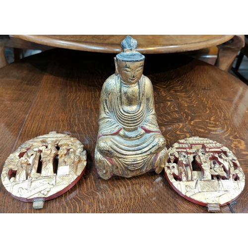 346 - A Chinese carved wood gilt figure of a seated buddha and 2 Chinese circular carved wood wall plaques