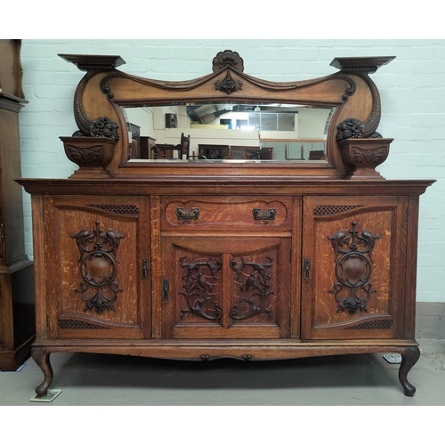 658 - A late 19th century Scottish golden oak mirror back sideboard with extensive carved decoration to th... 