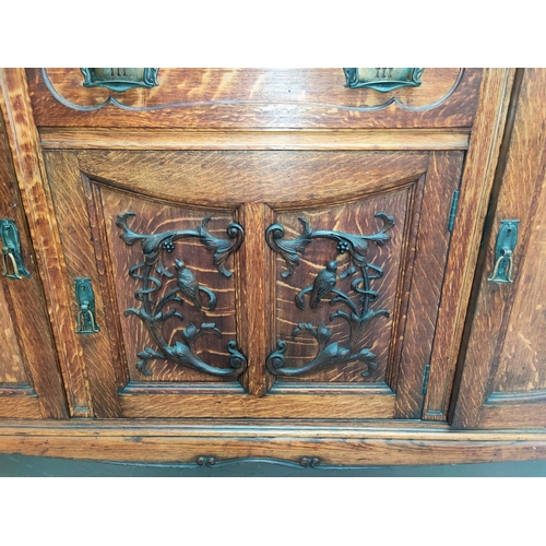 658 - A late 19th century Scottish golden oak mirror back sideboard with extensive carved decoration to th... 