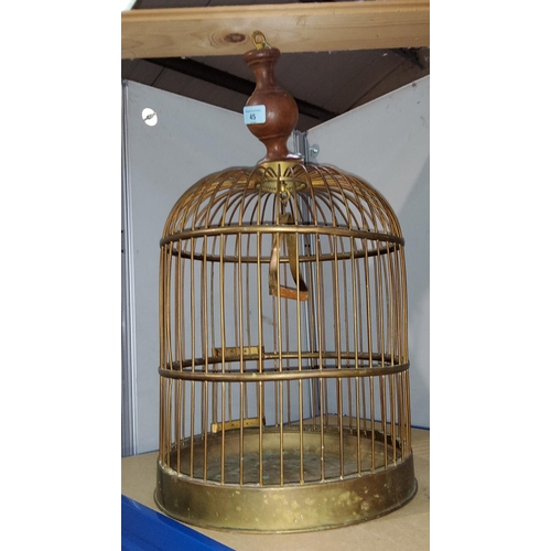 45 - An antique style brass bird cage with wooden hanger