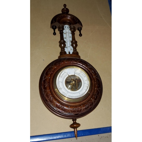 56 - A walnut cased aneroid wall hanging barometer