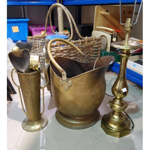 21 - A brass coal helmet and companion set; a large brass table lamp; a log basket; etc.