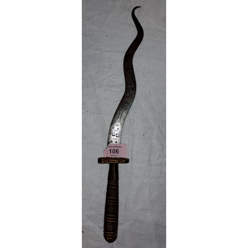 106 - An unusual ceremonial knife with wooden carved and wire wrapped handle with snaking blade decorated ... 