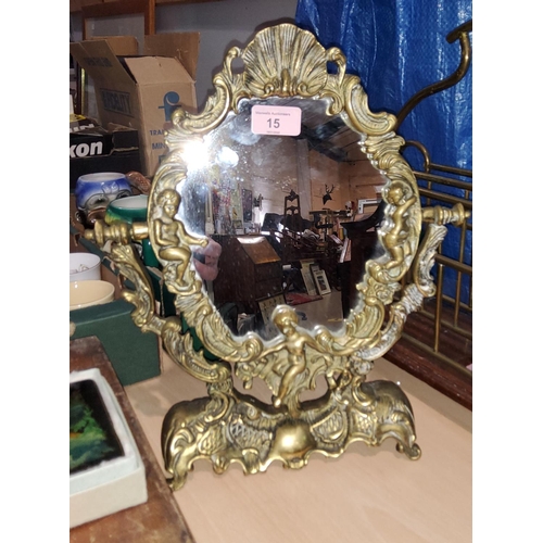 15 - A brass classical style swing dressing table mirror decorated with cherubs etc, height 38cm