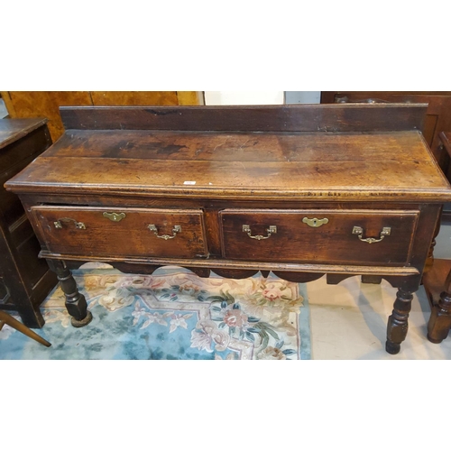 916 - A small18th century oak dresser base with 2 frieze drawers with later handles on turned front legs, ... 