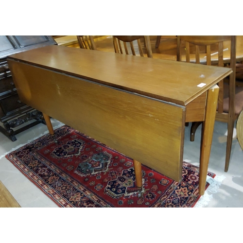 883 - A 1960's teak side/dining table with rectangular top and single drop leaf, by Elliotts of Newbury; a... 