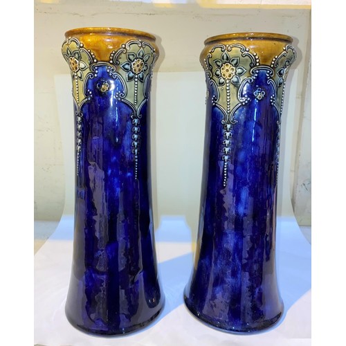 513 - A pair of Art Nouveau period cylindrical Royal Doulton stoneware vases decorated in relief with flow... 