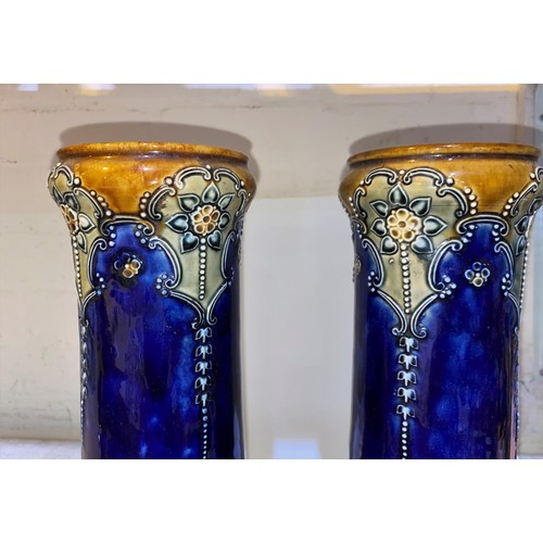 513 - A pair of Art Nouveau period cylindrical Royal Doulton stoneware vases decorated in relief with flow... 