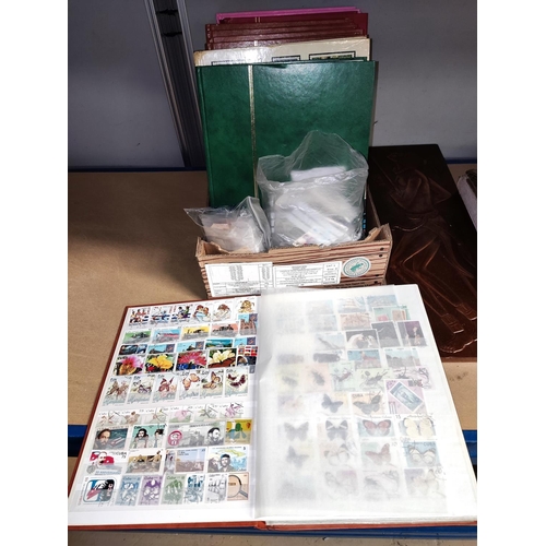 34 - Two stockbooks with stamps; 2 packets of British stamps; 9 empty stockbooks; etc..