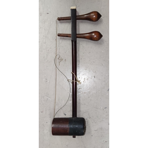 33 - An Erhu (Chinese Violin) in stained wood with two strings, snake skin back (split)