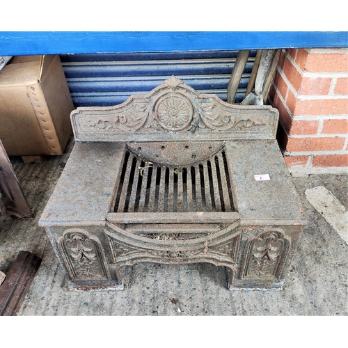 2 - A cast iron fireplace with grate