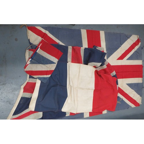 Four Various WW2 Period Flags consisting 47 x 68 inch, printed cotton Union Jack. Some damage ... 34 x 74 inch, stitched linen Union Jack ... 25 x 52 inch, stitched cotton French flag ... 32 x 46 inch, printed cotton Union Jack. 4 items.