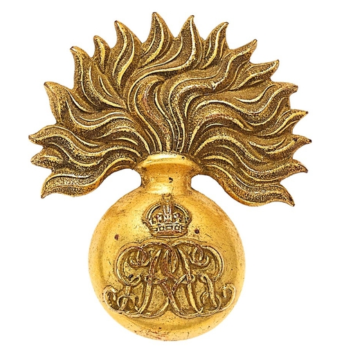 Grenadier Guards GvR Sergeant cap badge circa 1910-35.  Good scarce die-stamped gilded brass flaming grenade, the ball bearing crowned GR cypher, reversed and interlaced.   . Loops . Gilt toned. VGC