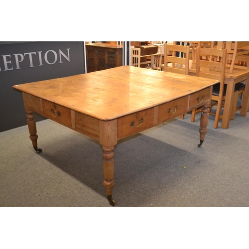 Impressive farmhouse kitchen table with wide pine boards to top and eight drawers, on castors with turned legs w173cm x d144cm x h79cm