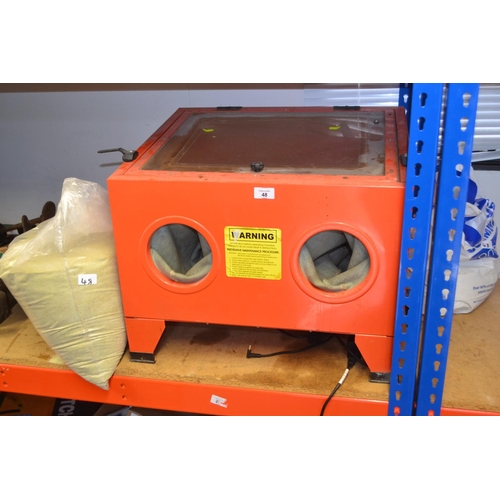 Airpowered sandblasting box with 2 bags of sand.