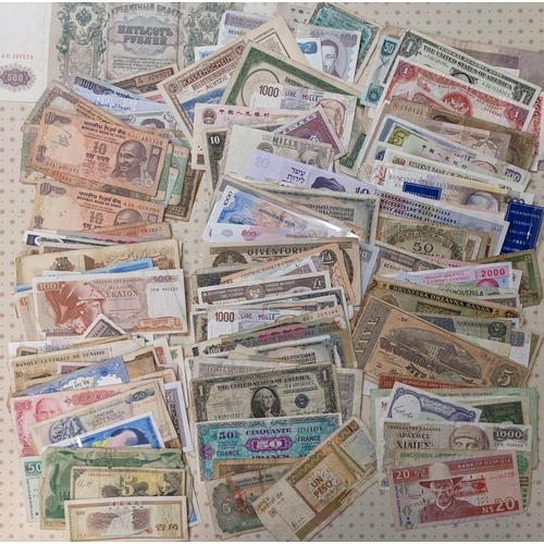 43 - Banknotes; a very mixed bundle of foreign (i.e. non-UK) notes from a wide variety of countries. Mixe... 