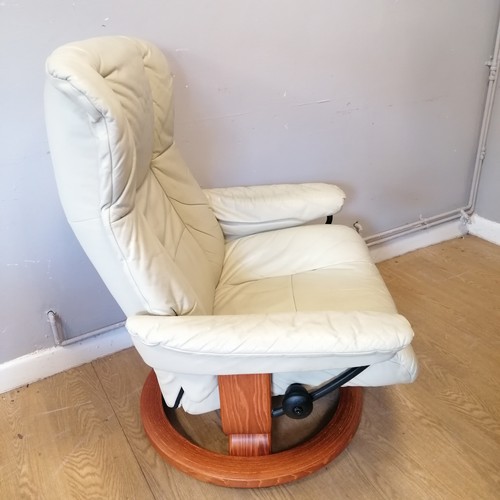 603 - Vintage cream leather 'stressless' swivel chair and footstool in good used condition. width 88cm x h... 