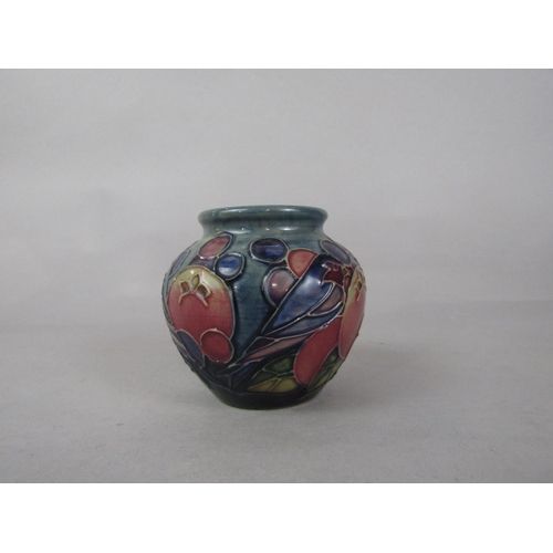1050 - A Moorcroft low vase in the Finch and Fruit pattern with impressed marks to base, 7.5cm tall approx