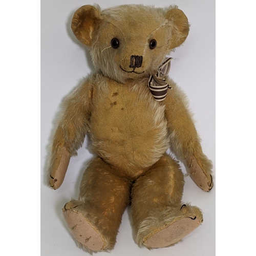 1 - 1930's teddy bear possibly by Merrythought with golden mohair, slight humped back, glass eyes, stitc... 