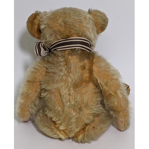 1 - 1930's teddy bear possibly by Merrythought with golden mohair, slight humped back, glass eyes, stitc... 