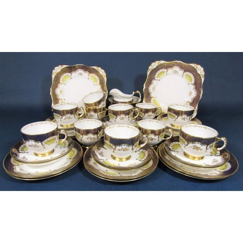 29 - A collection of Tuscan china teawares with blue and gilt decoration comprising pair of cake plates, ... 
