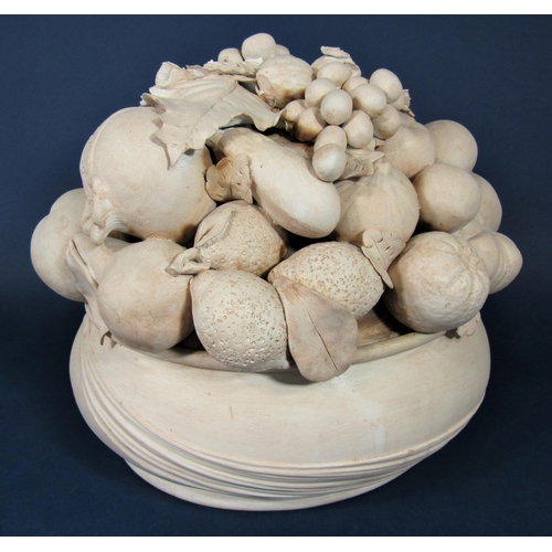62 - A terracotta model of a bowl of fruit including grapes, pomegranates, lemons, etc, 36cm tall approx
