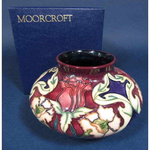 8 - A boxed Moorcroft vase of squat circular form with painted and moulded art nouveau style floral deta... 