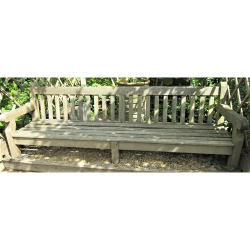 32 - A weathered teak wood garden bench, 240cm wide, reduced in height