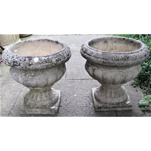 1509 - A pair of reclaimed Sandford stone garden urns, with flared repeating banded rims, lobed bowls, flut... 