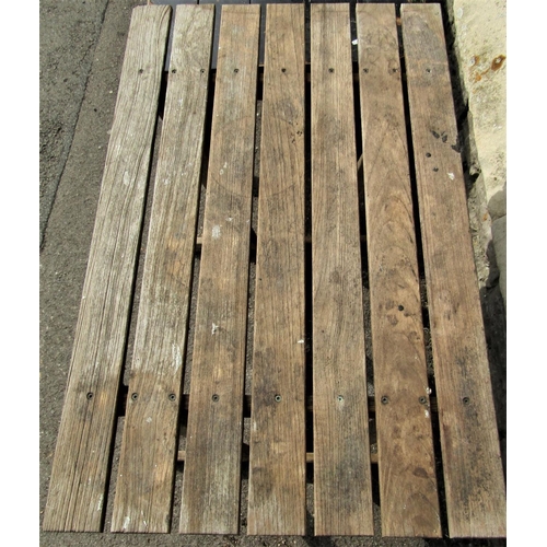1503 - An unusual weathered Lister teak garden table, with rectangular slatted top, angular supports and sl... 