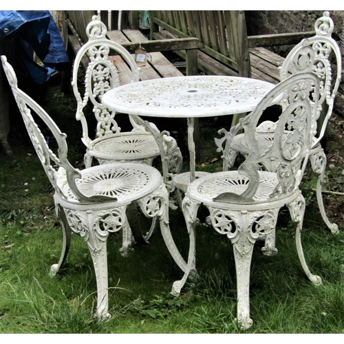1543 - A weathered cream painted cast aluminium garden terrace table with decorative circular pierced radia... 